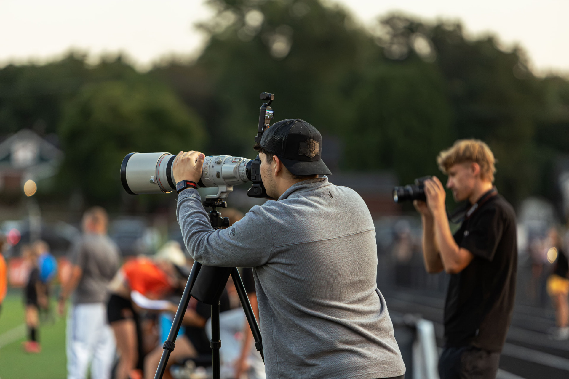 Titus Herbert shooting a football game with a long telephoto lens from the sideline
