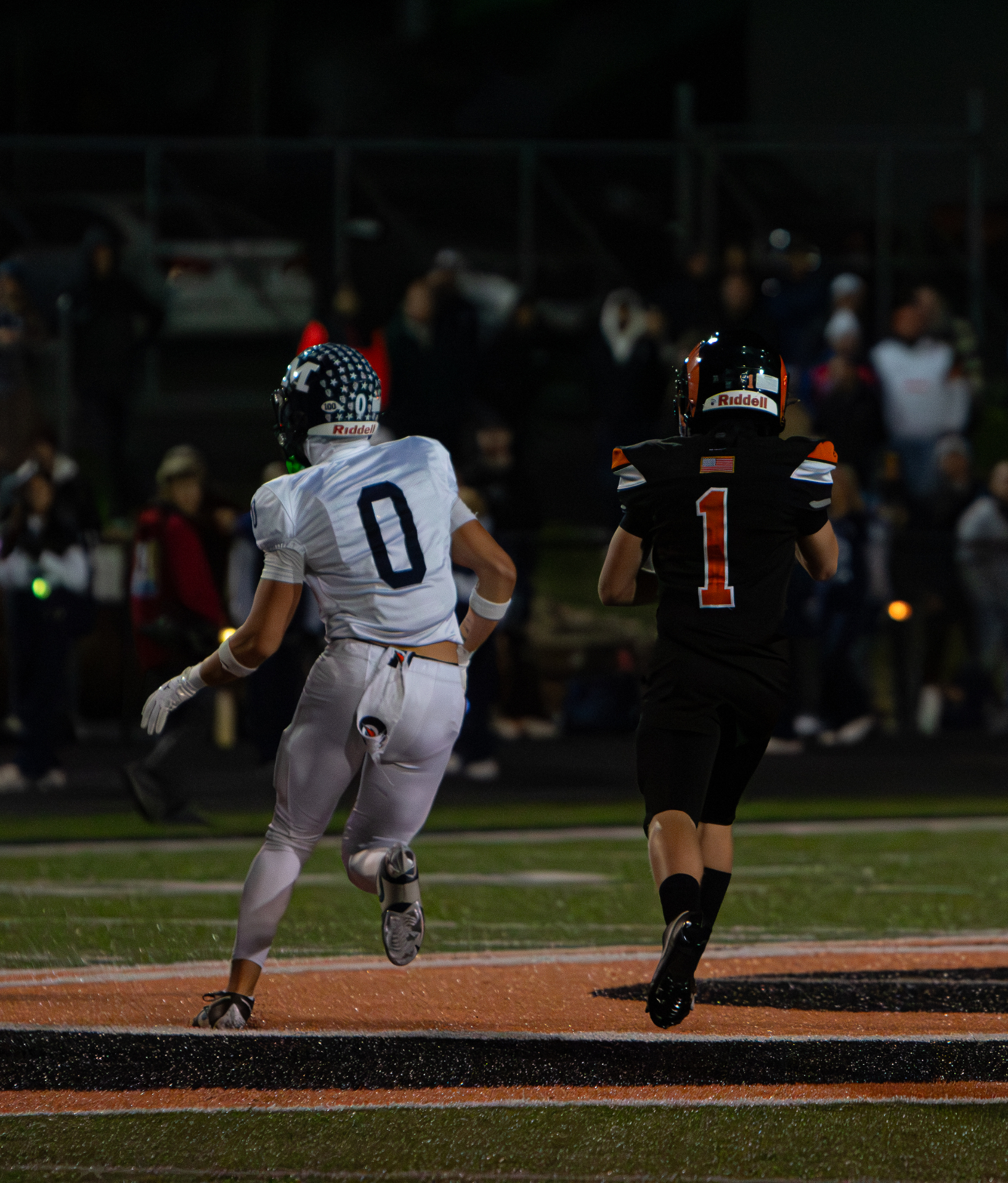 High school football running back chasing the end zone — action photography by Striide